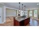 Open floor plan with granite kitchen island, hardwood floors, and cozy fireplace at 7804 Gusty Trl, Douglasville, GA 30135