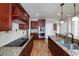 Gourmet kitchen boasts stainless steel appliances, granite counters, and custom wood cabinetry at 7804 Gusty Trl, Douglasville, GA 30135