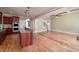 Spacious kitchen with granite countertops, island with bar seating, and views into a large living space at 7804 Gusty Trl, Douglasville, GA 30135