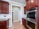 Kitchen area features stainless steel oven and wooden cabinets at 7804 Gusty Trl, Douglasville, GA 30135