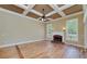 Spacious living room featuring coffered ceilings, a brick fireplace, and large windows at 7804 Gusty Trl, Douglasville, GA 30135