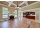 Open-concept living room with hardwood floors, fireplace, and seamless flow to the kitchen at 7804 Gusty Trl, Douglasville, GA 30135