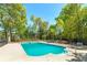 Refreshing in-ground swimming pool with a diving board, surrounded by ample lounge space and mature trees at 7804 Gusty Trl, Douglasville, GA 30135
