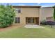 Private backyard features a covered patio and lush greenery, perfect for outdoor entertaining at 8360 Village School Dr, Cumming, GA 30041