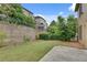 Picturesque backyard with retaining wall providing privacy with surrounding greenery and neighboring houses at 8360 Village School Dr, Cumming, GA 30041