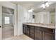 Bathroom featuring double sinks and granite countertops at 8360 Village School Dr, Cumming, GA 30041