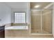 Bathroom featuring a large bathtub and shower at 8360 Village School Dr, Cumming, GA 30041