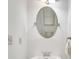 Cozy bathroom featuring a white sink, oval mirror, and decorative accents at 8360 Village School Dr, Cumming, GA 30041
