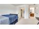 Spacious bedroom featuring a walk-in closet, ensuite bathroom, and plush carpeting at 8360 Village School Dr, Cumming, GA 30041