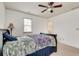 Comfortable bedroom with plush carpet, a ceiling fan, and access to a convenient walk-in closet at 8360 Village School Dr, Cumming, GA 30041