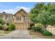 Beautiful home featuring a two-car garage and meticulously maintained landscaping at 8360 Village School Dr, Cumming, GA 30041