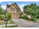 Beautiful home featuring a two-car garage and meticulously maintained landscaping at 8360 Village School Dr, Cumming, GA 30041