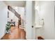 Open entry showcasing hardwood floors, a staircase, and a convenient powder room at 8360 Village School Dr, Cumming, GA 30041