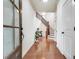 Welcoming foyer featuring hardwood floors, elegant lighting, and a staircase at 8360 Village School Dr, Cumming, GA 30041