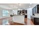 Stylish kitchen with a breakfast bar, stainless steel appliances, and dark wood cabinetry at 8360 Village School Dr, Cumming, GA 30041