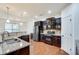 Modern kitchen with stainless steel appliances, granite countertops, and dark wood cabinets at 8360 Village School Dr, Cumming, GA 30041