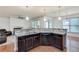 Eat-in kitchen featuring dark wood cabinets, granite countertops and modern stainless steel appliances at 8360 Village School Dr, Cumming, GA 30041