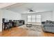 Spacious living room featuring hardwood floors, gray couches, and lots of natural light at 8360 Village School Dr, Cumming, GA 30041