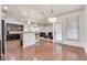 Bright open-concept living space with a modern kitchen and hardwood floors at 8360 Village School Dr, Cumming, GA 30041