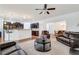 Open concept living room with a breakfast bar area, leather furniture, and natural light at 8360 Village School Dr, Cumming, GA 30041