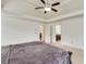 Main bedroom with carpet, ceiling fan, and view of the bathroom at 8360 Village School Dr, Cumming, GA 30041
