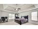 Main bedroom featuring a ceiling fan, carpet, and desk at 8360 Village School Dr, Cumming, GA 30041