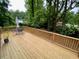 Large wooden deck with a seating area overlooking the landscaped backyard at 1177 Baker Ln, Marietta, GA 30062
