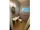 Cozy bathroom with window, pedestal sink and muted purple tile at 1177 Baker Ln, Marietta, GA 30062