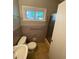 Compact bathroom with stand up shower, window and muted purple tile at 1177 Baker Ln, Marietta, GA 30062