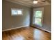 Bedroom with hardwood floors and natural light from windows at 1177 Baker Ln, Marietta, GA 30062
