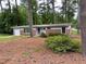 A charming brick home sitting on a lot covered in mature trees at 1177 Baker Ln, Marietta, GA 30062