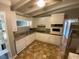 Well-equipped kitchen with stainless steel refrigerator and granite countertops at 1177 Baker Ln, Marietta, GA 30062