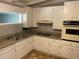 Bright kitchen featuring white cabinets and granite countertops at 1177 Baker Ln, Marietta, GA 30062