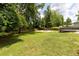 Spacious backyard with green grass, a wooden fence, and a sports court at 3185 Perch Sw Dr, Marietta, GA 30008
