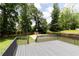 Grey deck overlooking large backyard with a sports court at 3185 Perch Sw Dr, Marietta, GA 30008
