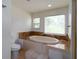 Relaxing bathroom with a large soaking tub and tile surround at 3185 Perch Sw Dr, Marietta, GA 30008