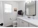 Bathroom with a white vanity, black framed mirror, and shower and tub combination at 3185 Perch Sw Dr, Marietta, GA 30008
