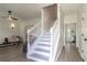 Bright entryway with a staircase, light wood floors, and a view of the living room at 3185 Perch Sw Dr, Marietta, GA 30008