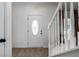 Entryway with a decorative front door, white trim, and light wood-look flooring at 3185 Perch Sw Dr, Marietta, GA 30008