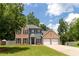 Two-story brick and gray home with a well-manicured lawn and an attached two-car garage at 3185 Perch Sw Dr, Marietta, GA 30008