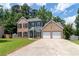Charming two-story home boasts a mix of brick and siding with a two-car attached garage at 3185 Perch Sw Dr, Marietta, GA 30008