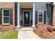 Close-up of the front door area featuring decorative columns and potted flowers at 3185 Perch Sw Dr, Marietta, GA 30008