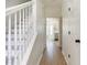 Hallway leading to the kitchen, featuring white trim and light wood-look flooring at 3185 Perch Sw Dr, Marietta, GA 30008