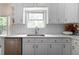 Kitchen features white subway tiles, a stainless steel dishwasher, and ample counter space at 3185 Perch Sw Dr, Marietta, GA 30008