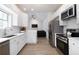 Modern kitchen with stainless steel appliances, white cabinetry, and plenty of counter space at 3185 Perch Sw Dr, Marietta, GA 30008