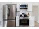 Kitchen features modern stainless steel appliances, white cabinets, and sleek countertops at 3185 Perch Sw Dr, Marietta, GA 30008