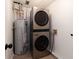 Laundry room featuring a stackable washer and dryer, and a water heater at 3185 Perch Sw Dr, Marietta, GA 30008