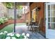 Serene back patio surrounded by brick walls and lush greenery, creating a tranquil outdoor space at 3280 Stillhouse Se Ln # 108, Atlanta, GA 30339