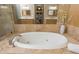 A close up of a luxurious bathtub, faucet, marble surround and a window reflected in the mirror at 3280 Stillhouse Se Ln # 108, Atlanta, GA 30339