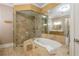 Elegant bathroom featuring marble shower and tub, stone countertop and an elegant vanity at 3280 Stillhouse Se Ln # 108, Atlanta, GA 30339